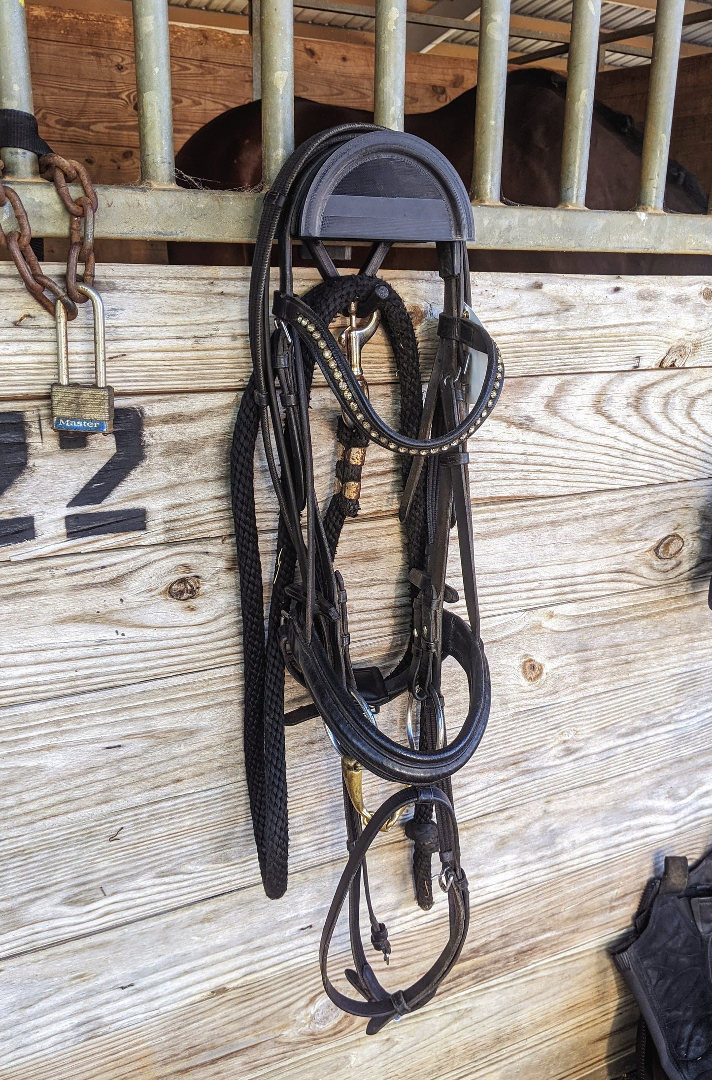 travel bridle holder on stall wall