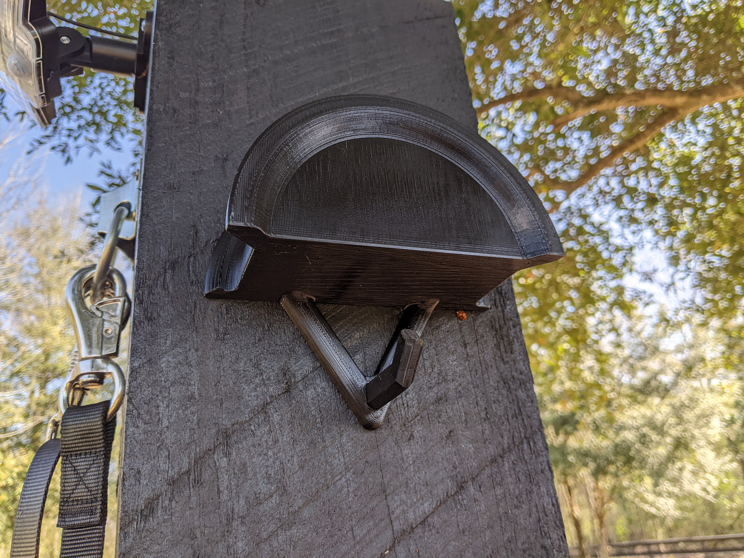 Wall mount bridle holder in black on wash rack post from bottom